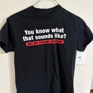 Spencer's Graphic Black Tee expletive “Not my f*^@!ing problem”.